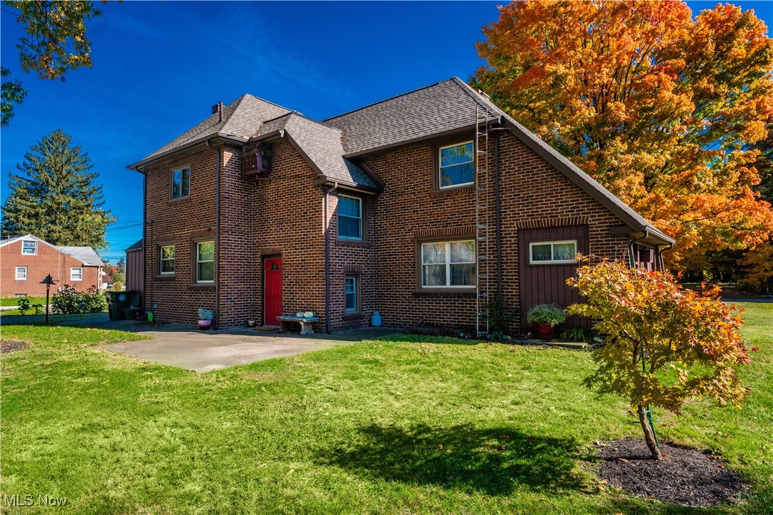 915 Raff Road Southwest Canton, OH 44710 - Photo 2 of 25 Rear view of house featuring a yard and a patio