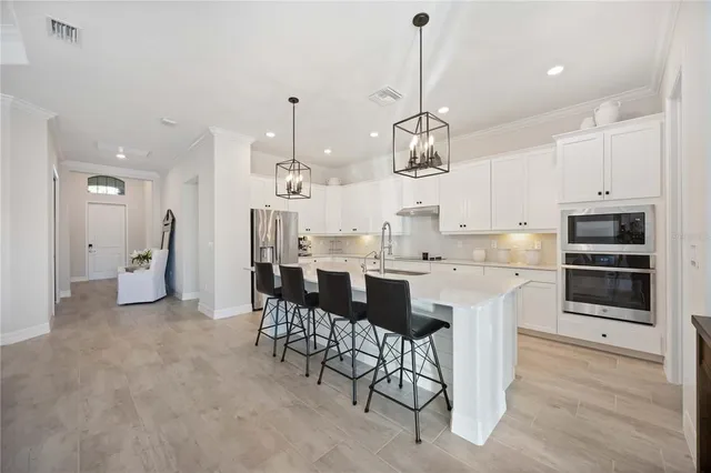 a kitchen with stainless steel appliances a cabinets and a refrigerator