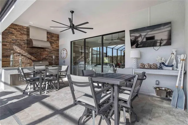 an aerial view of residential houses with outdoor space and trees
