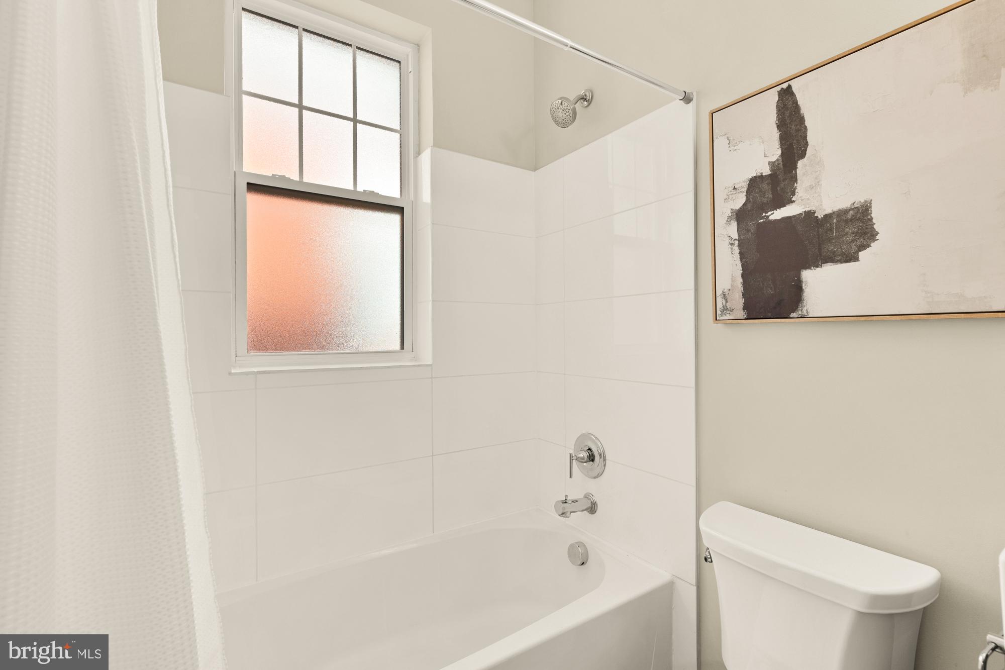 315 G Street Northeast, Unit 303 Washington, DC 20002 - Photo 13 of 16 a white toilet sitting next to a bath tub
