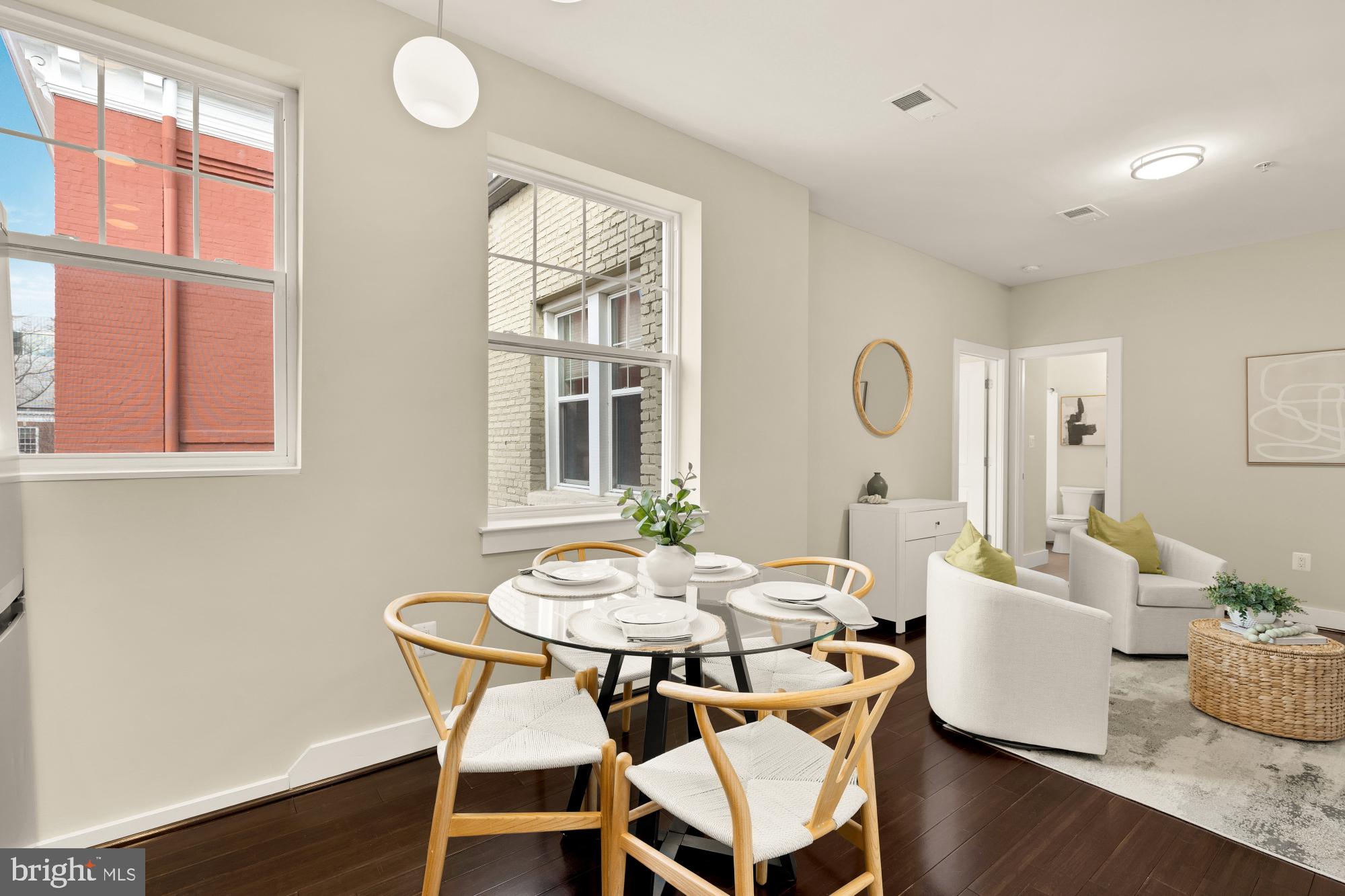315 G Street Northeast, Unit 303 Washington, DC 20002 - Photo 4 of 16 a view of a dining room with furniture wooden floor and a chandelier