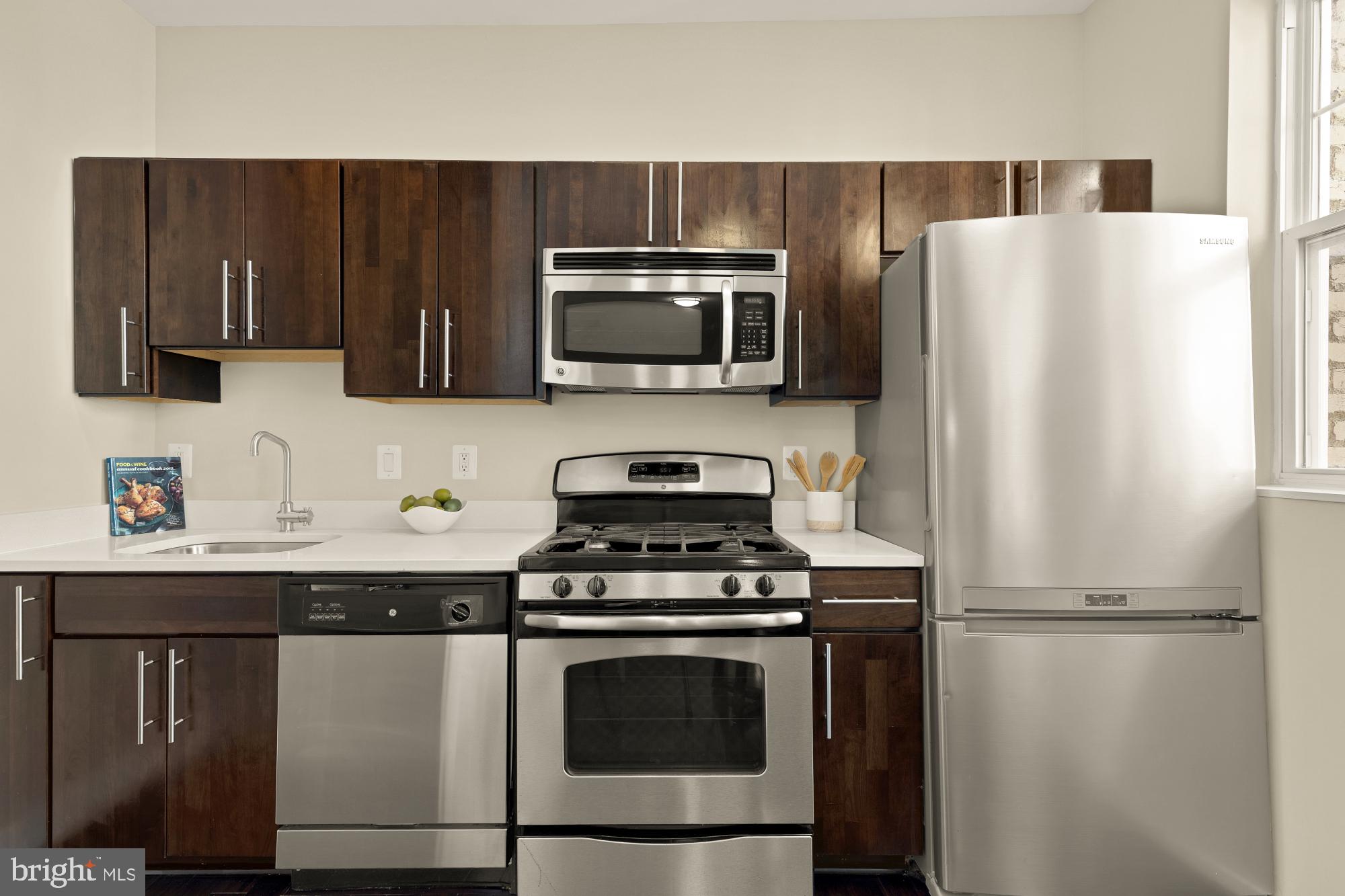315 G Street Northeast, Unit 303 Washington, DC 20002 - Photo 7 of 16 a kitchen with a stove and a microwave
