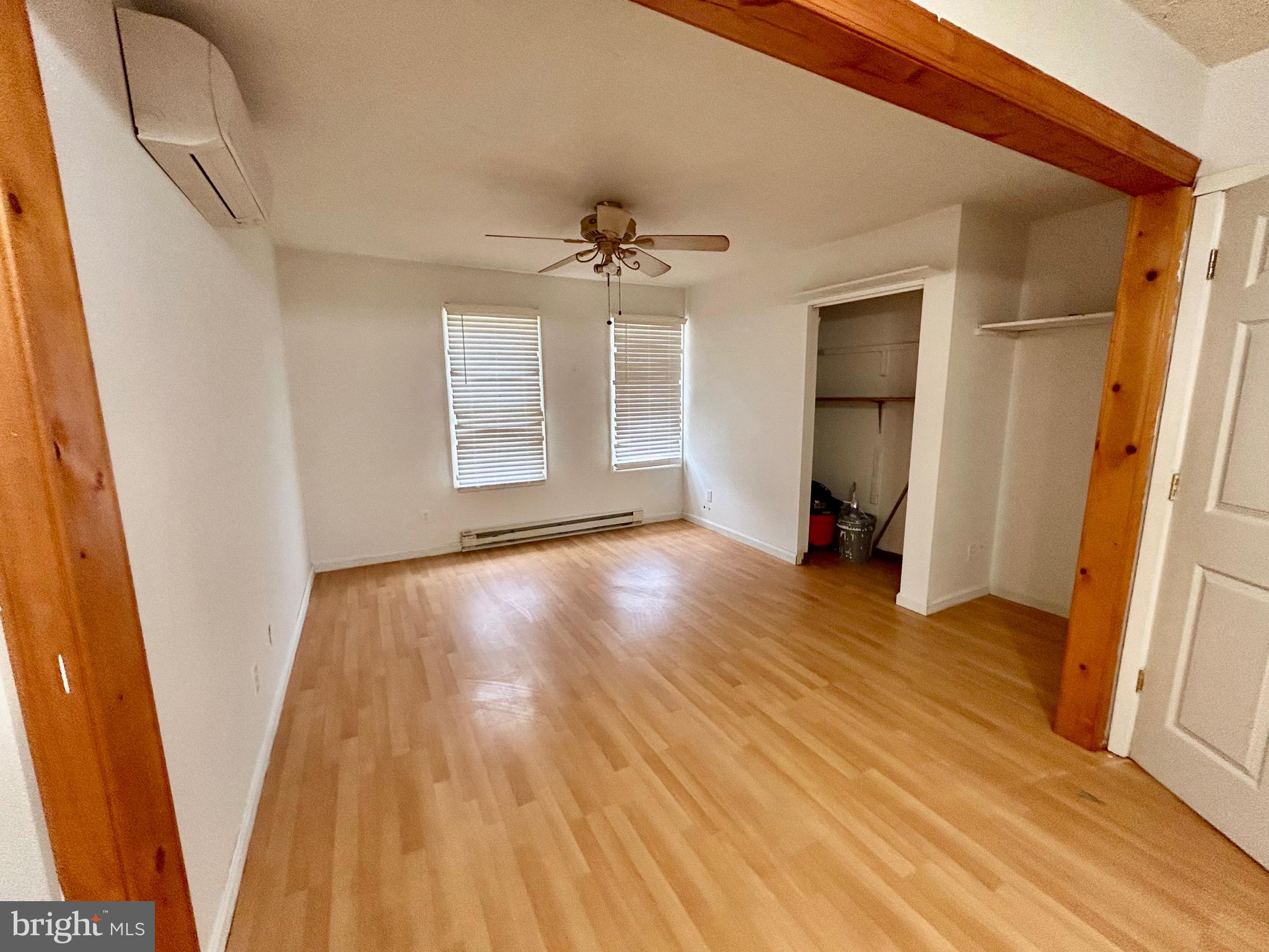 208 Justice Way Elkton, MD 21921 - Photo 13 of 23 wooden floor in an empty room with a window