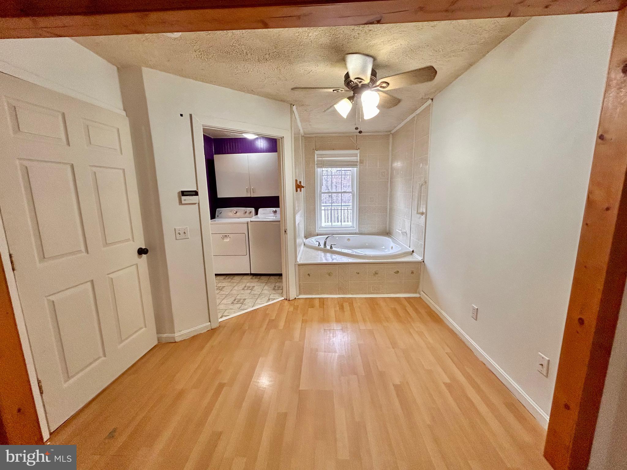 208 Justice Way Elkton, MD 21921 - Photo 15 of 23 a view of an empty room with wooden floor and a window