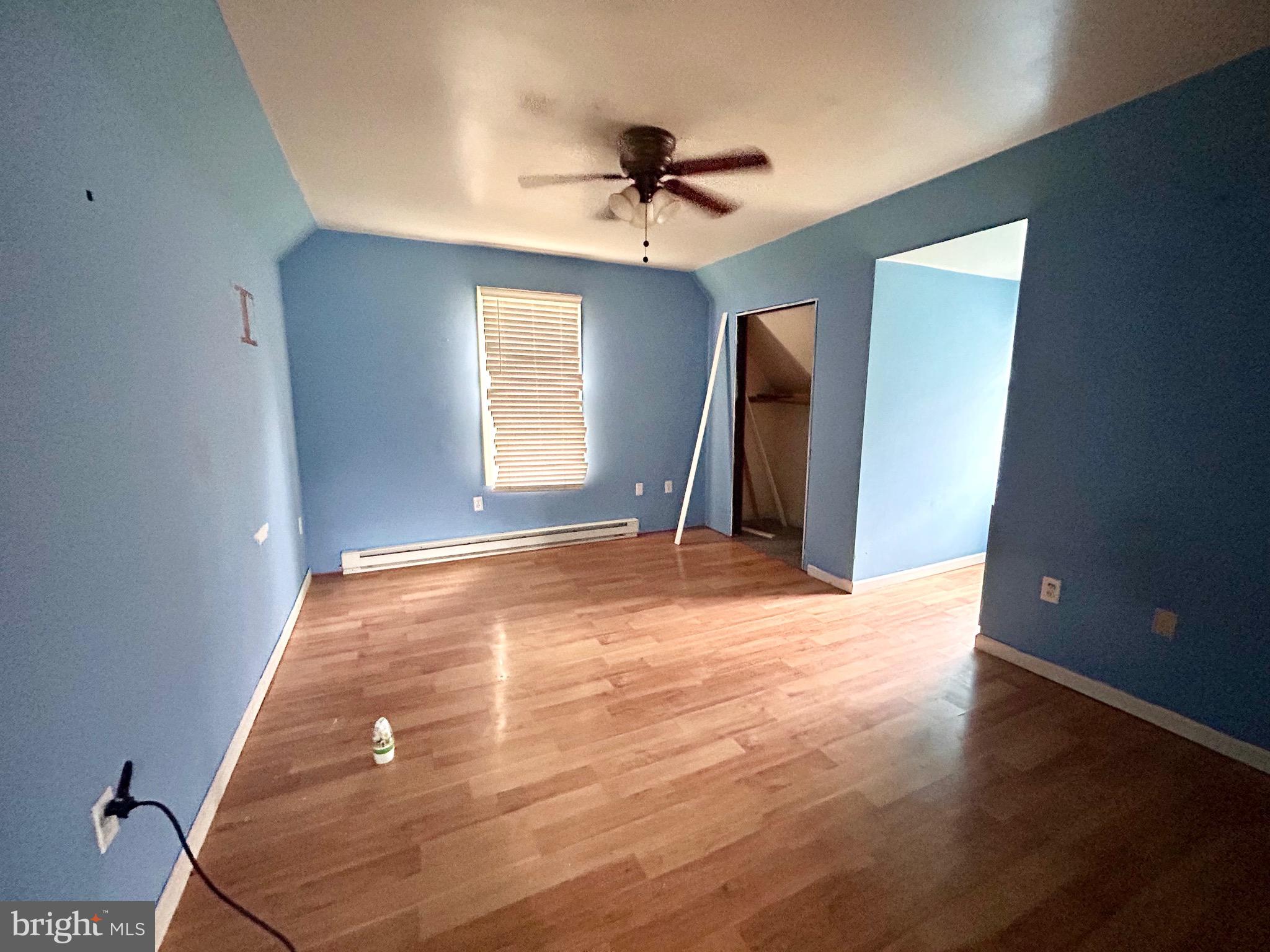 208 Justice Way Elkton, MD 21921 - Photo 17 of 23 wooden floor in an empty room with a window