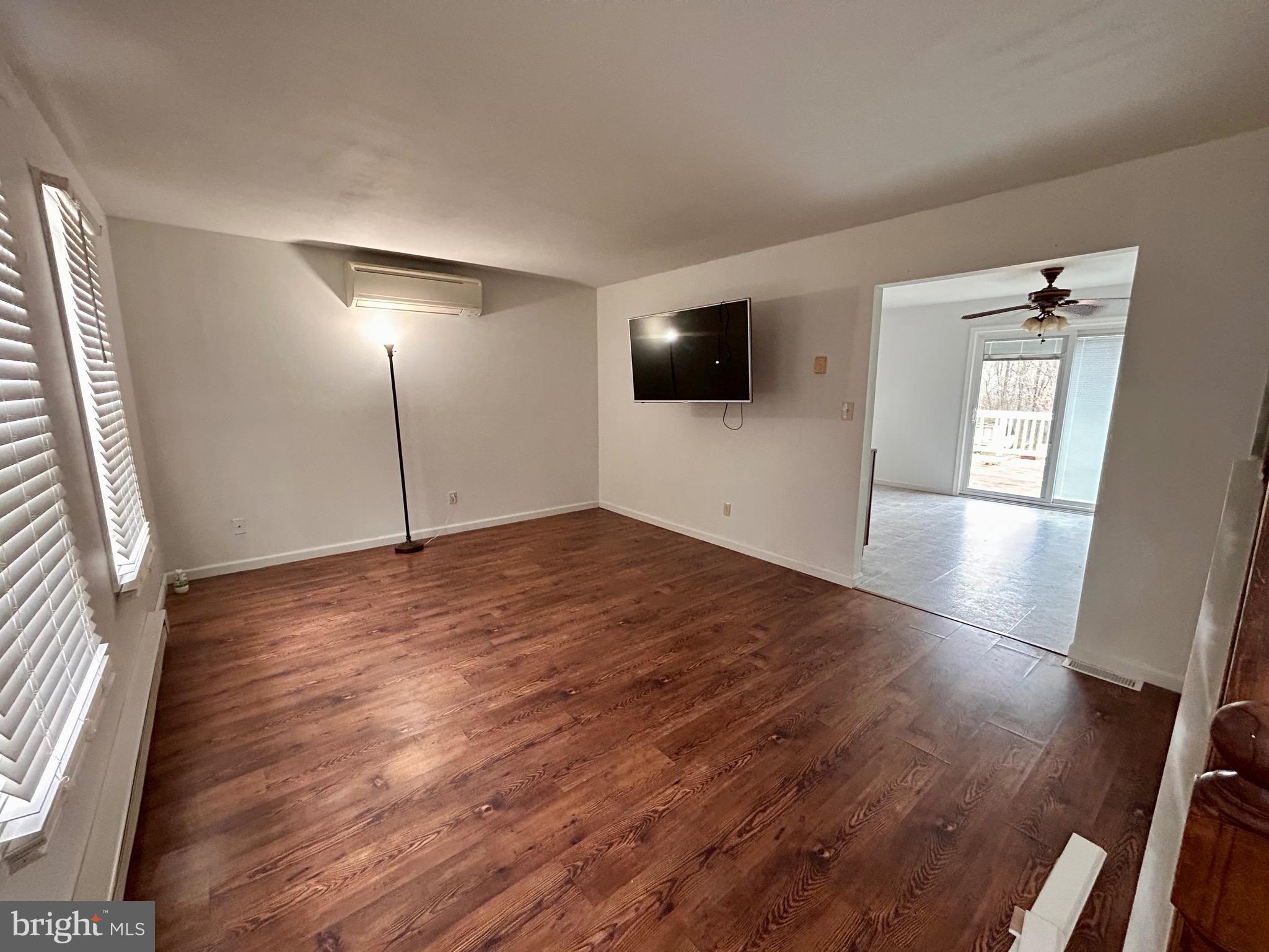 208 Justice Way Elkton, MD 21921 - Photo 7 of 23 a view of empty room with wooden floor and fan