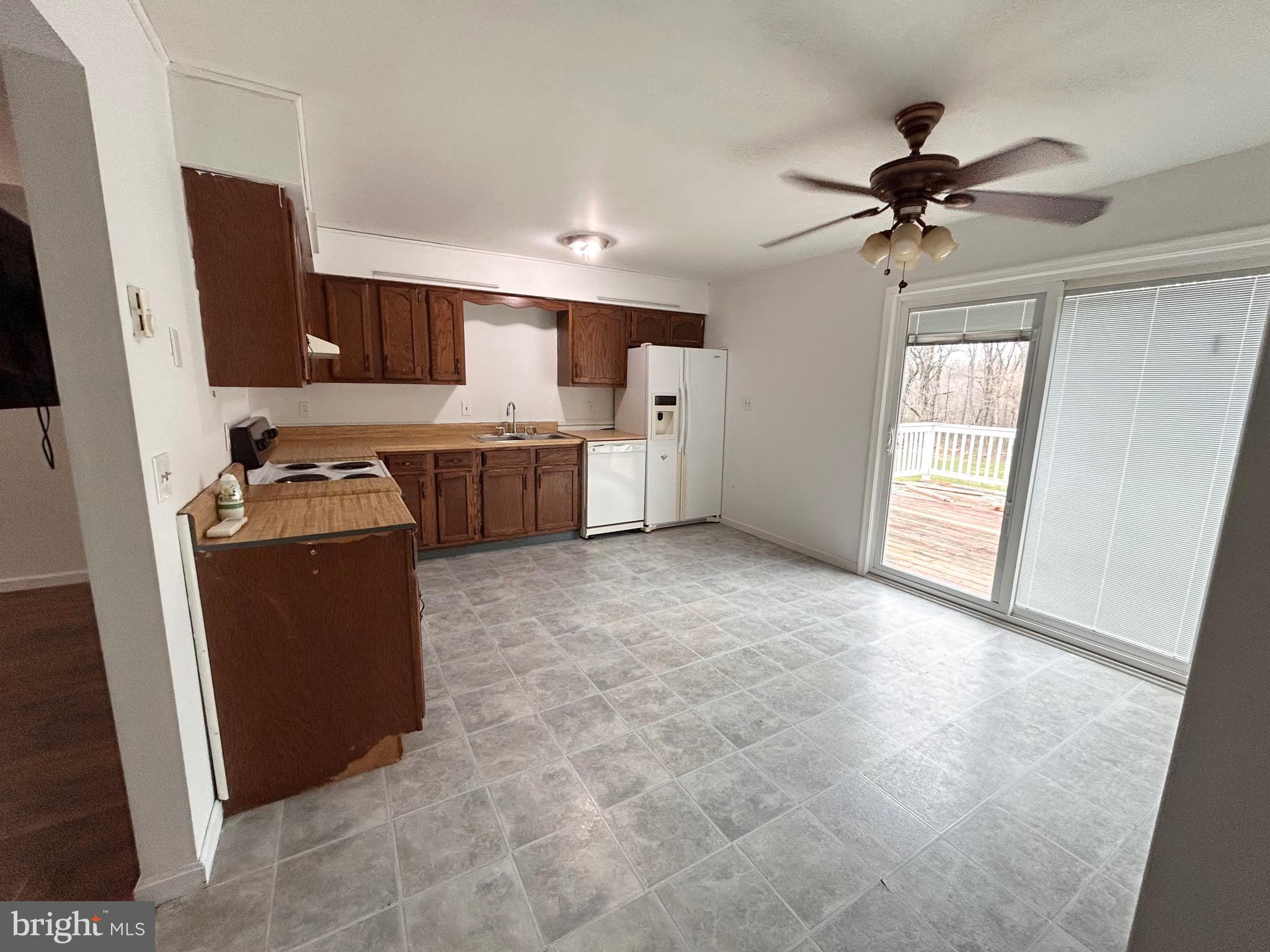 208 Justice Way Elkton, MD 21921 - Photo 8 of 23 a kitchen with a refrigerator a sink and a stove top oven