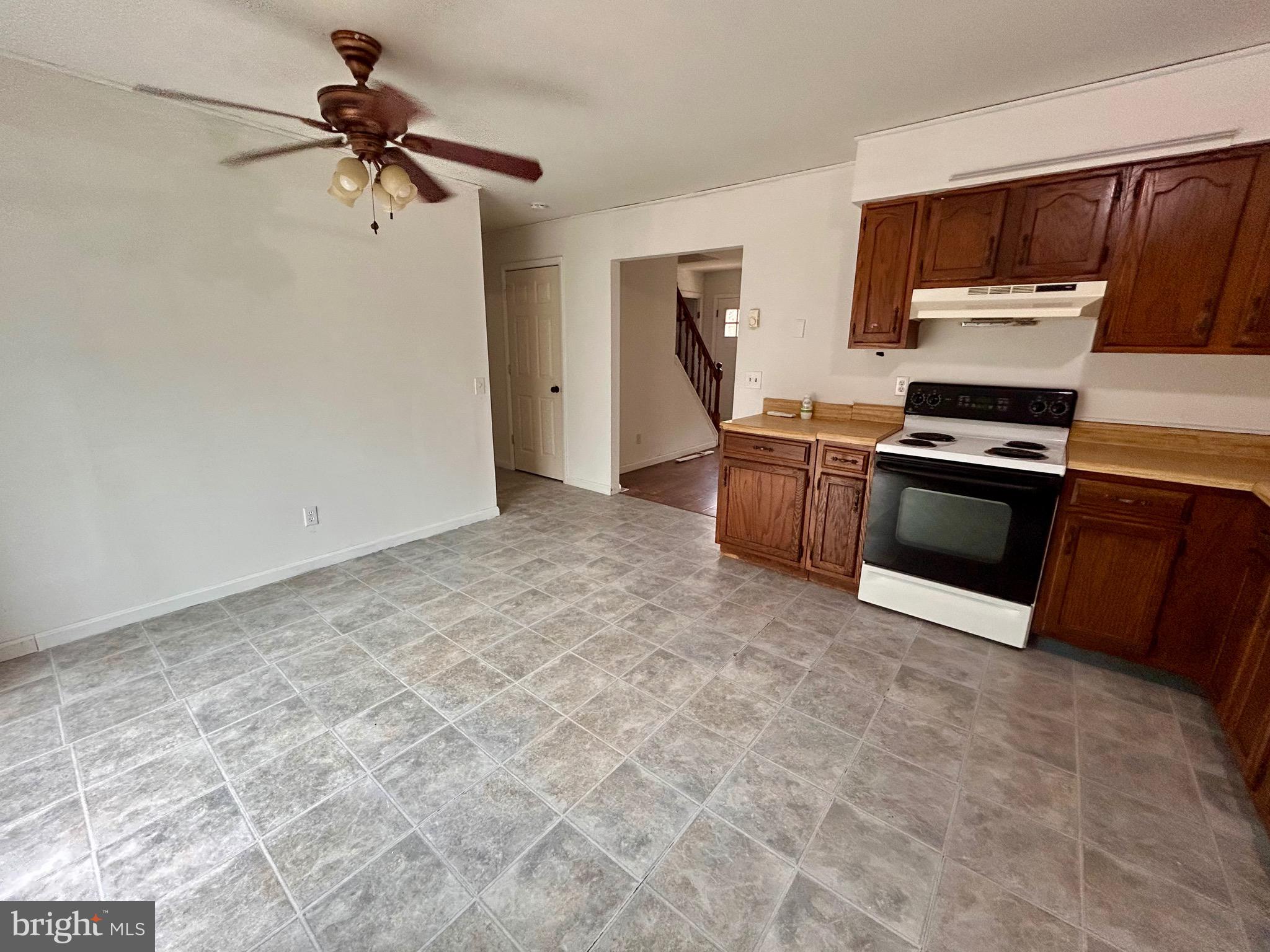 208 Justice Way Elkton, MD 21921 - Photo 9 of 23 a kitchen with granite countertop a stove cabinets and stainless steel appliances