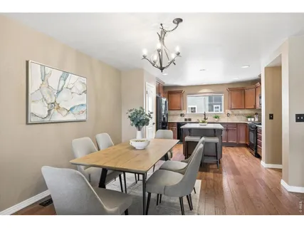 a view of a dining room with furniture wooden floor and a chandelier