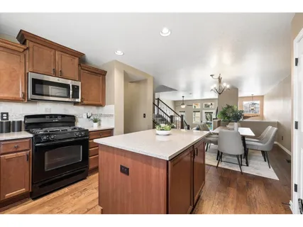 a kitchen with a stove a sink and a microwave