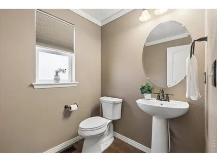 a bathroom with a sink mirror and toilet