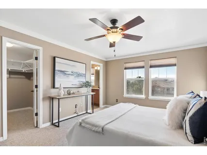 a bedroom with a bed and a large window