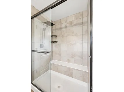a bathroom with a glass shower door