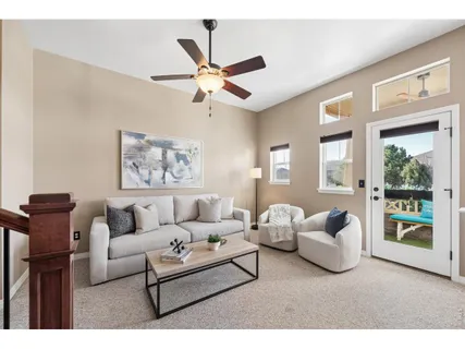 a living room with furniture and a large window