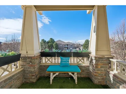 a balcony with table and chairs