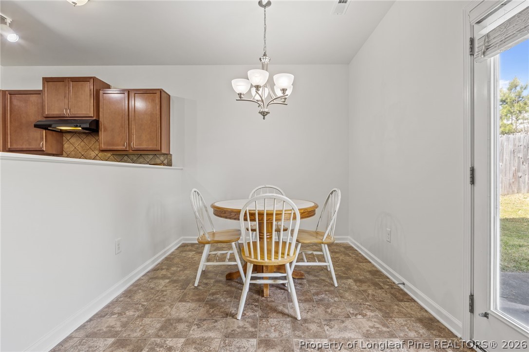 226 River Oak Street Spring Lake, NC 28390 - Photo 20 of 41 a dining room with a wooden table and chairs