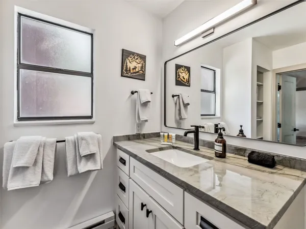 a bathroom with a double vanity sink and a mirror