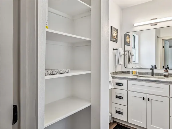 a bathroom with a double vanity sink and mirror