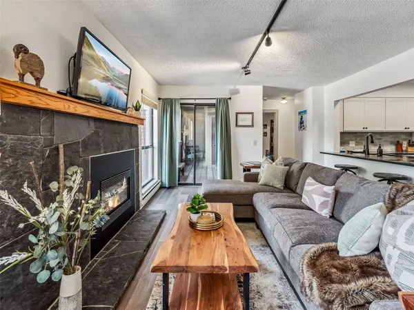 a living room with furniture fireplace and a window