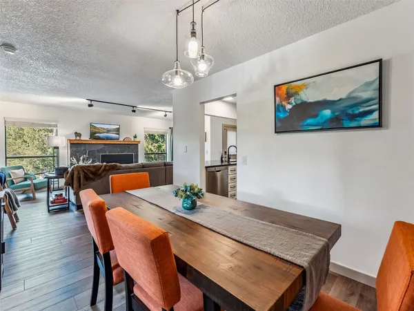 a view of a dining room with furniture wooden floor and chandelier