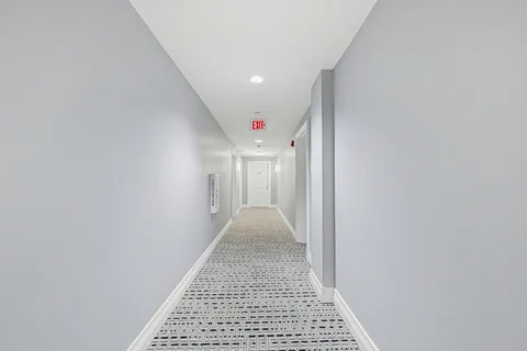 a view of a hallway with a white walls