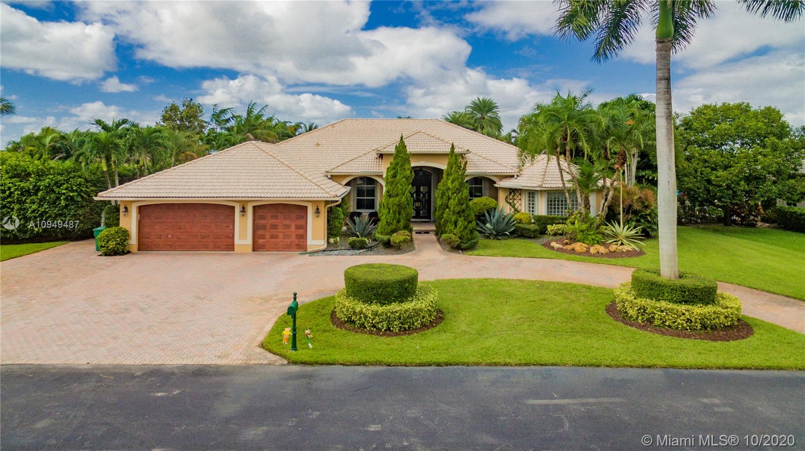 2273 Southwest 132nd Way Davie, FL 33325 - Photo 2 of 48 a front view of a house with a garden and plants