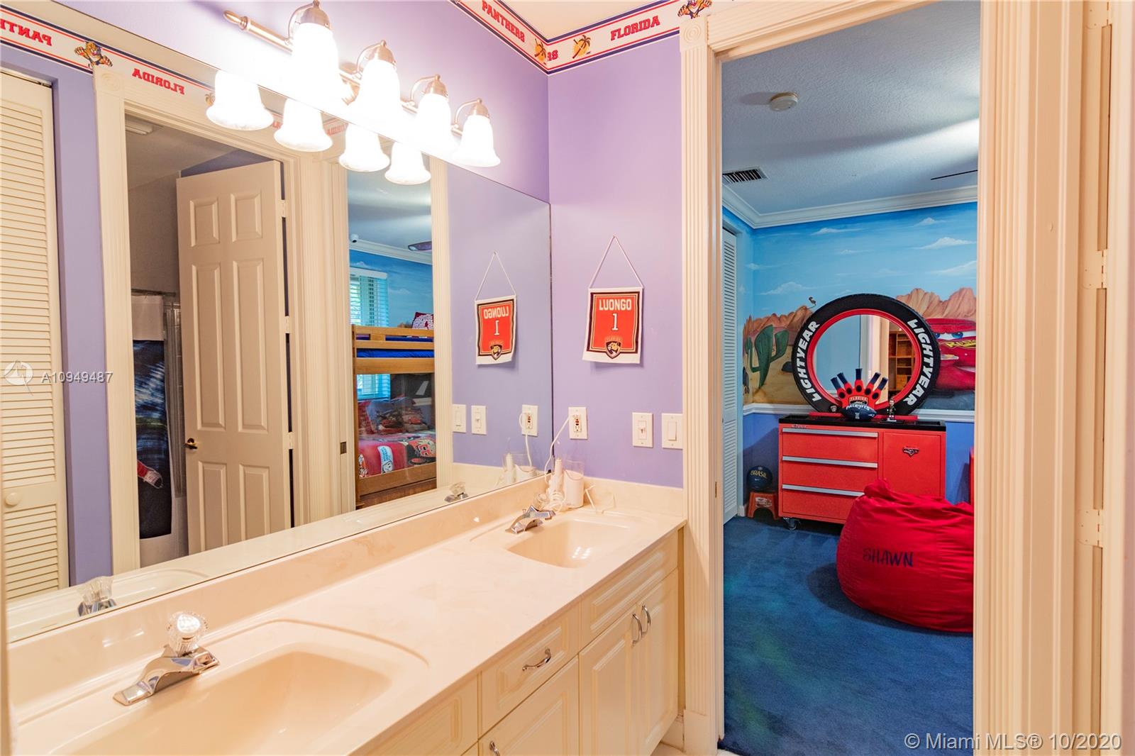 2273 Southwest 132nd Way Davie, FL 33325 - Photo 19 of 48 a en suite bathroom with a sink and a mirror