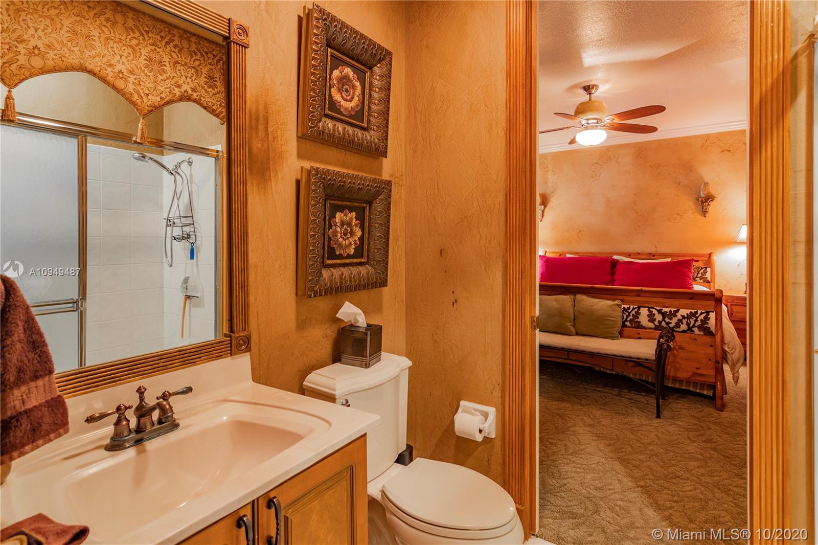 2273 Southwest 132nd Way Davie, FL 33325 - Photo 20 of 48 a bathroom with a sink vanity mirror and toilet