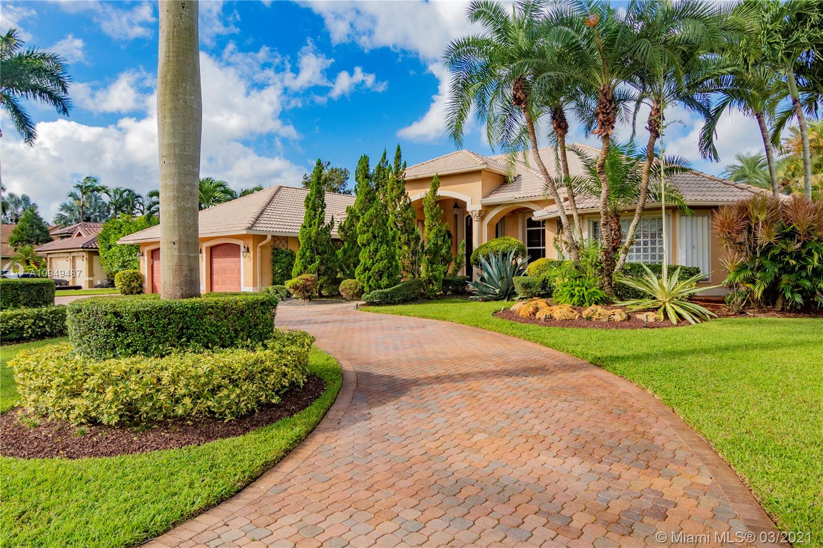 2273 Southwest 132nd Way Davie, FL 33325 - Photo 3 of 48 a view of a white house with a yard and potted plants