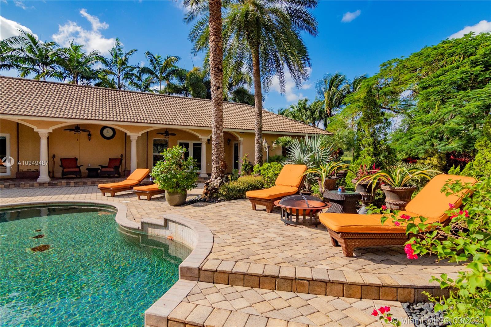 2273 Southwest 132nd Way Davie, FL 33325 - Photo 21 of 48 a view of a patio with table and chairs potted plants and palm tree