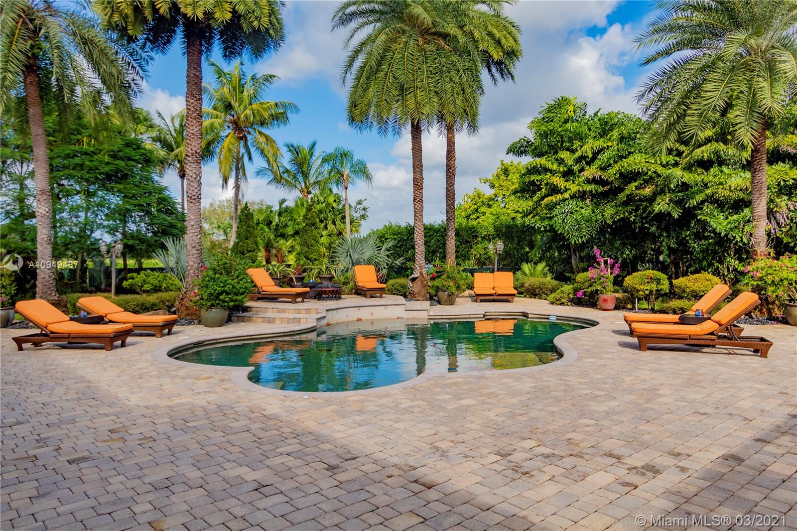 2273 Southwest 132nd Way Davie, FL 33325 - Photo 23 of 48 a view of a swimming pool with a lounge chair and palm trees