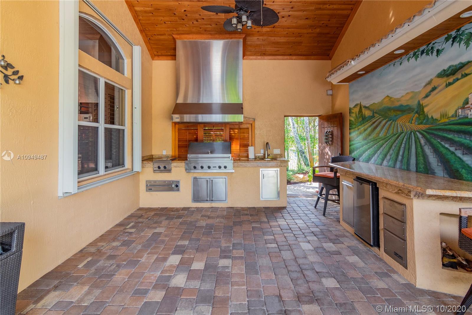 2273 Southwest 132nd Way Davie, FL 33325 - Photo 30 of 48 a kitchen with a stove a sink and a refrigerator