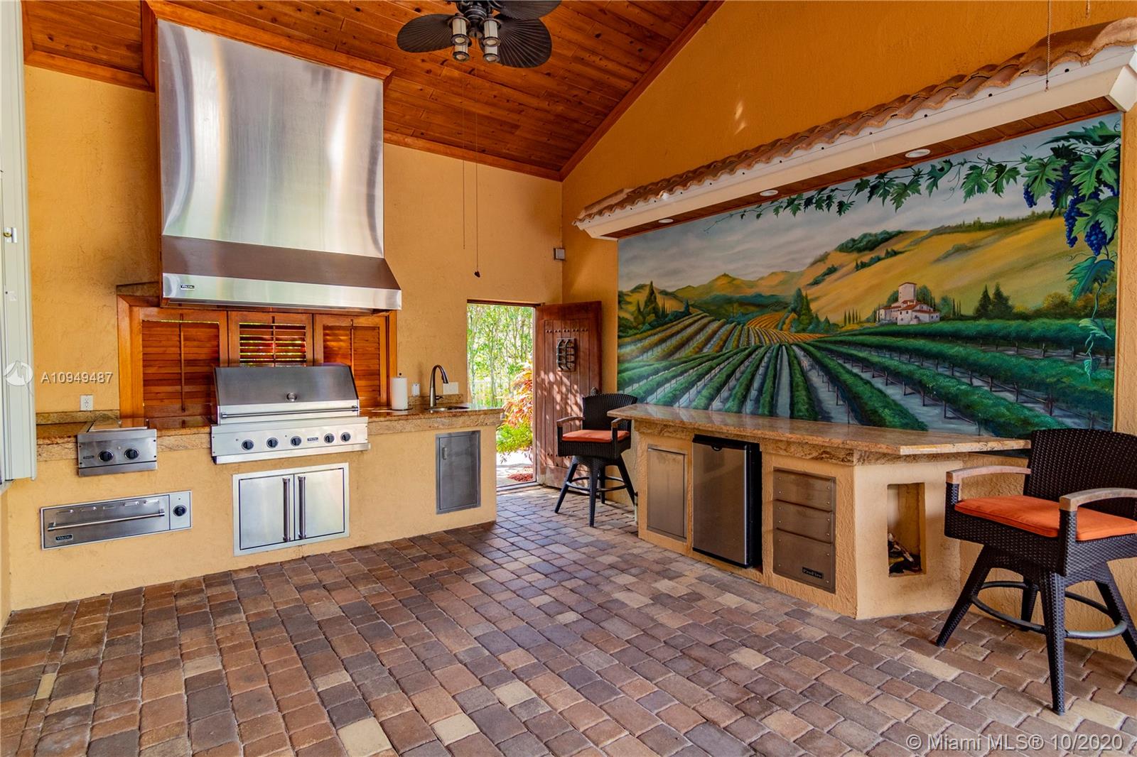 2273 Southwest 132nd Way Davie, FL 33325 - Photo 31 of 48 a kitchen with a stove a refrigerator and chairs