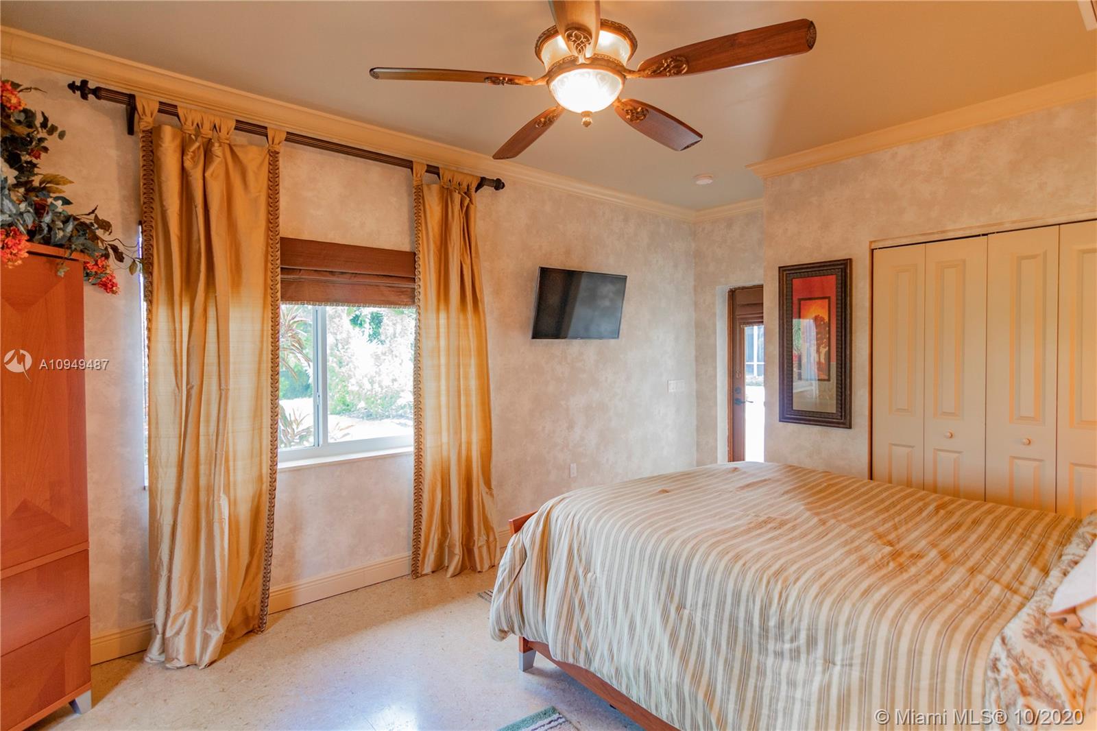 2273 Southwest 132nd Way Davie, FL 33325 - Photo 37 of 48 a bedroom with a large bed and a chandelier fan