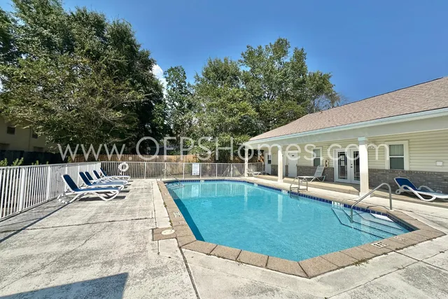 swimming pool view with a seating space