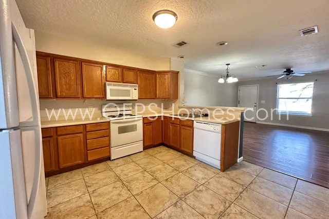 a kitchen with stainless steel appliances granite countertop a sink counter space cabinets and a window