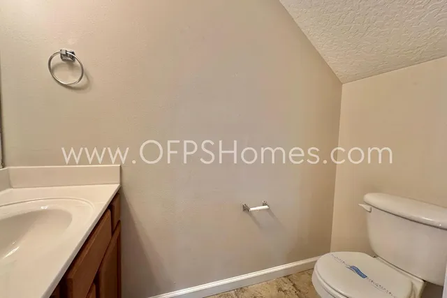 a bathroom with a shower curtain and a sink