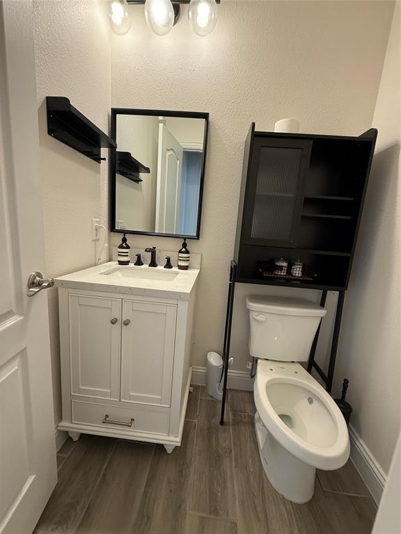 5212 Troupe Road McKinney, TX 75071 - Photo 11 of 38 Bathroom featuring a white vanity with a rectangular undermount sink, a dark-framed mirror, and a three-light fixture