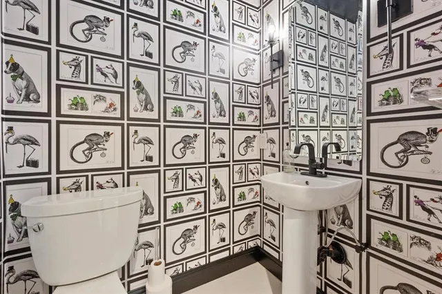 a bathroom with a toilet and a mirror