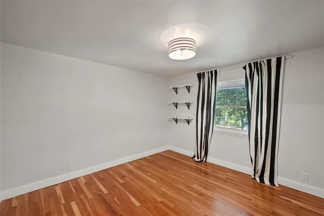 a room with wooden floor and furniture