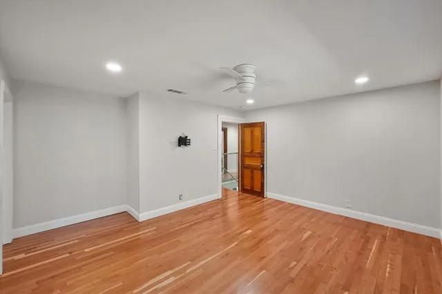 a bedroom with a large bed and a flat screen tv