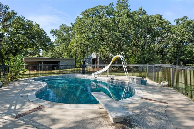 a view of a swimming pool with a yard