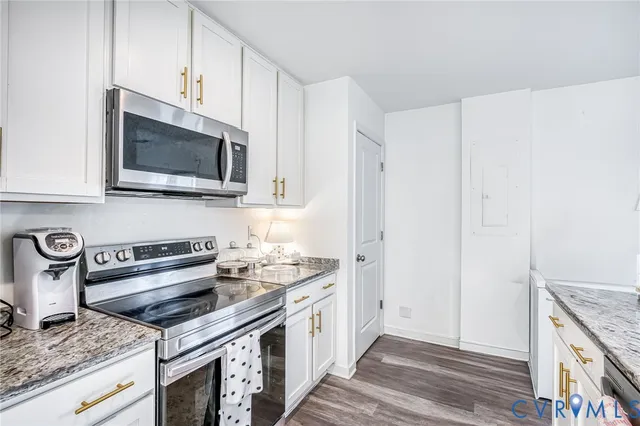 a kitchen with stainless steel appliances granite countertop a stove and a microwave