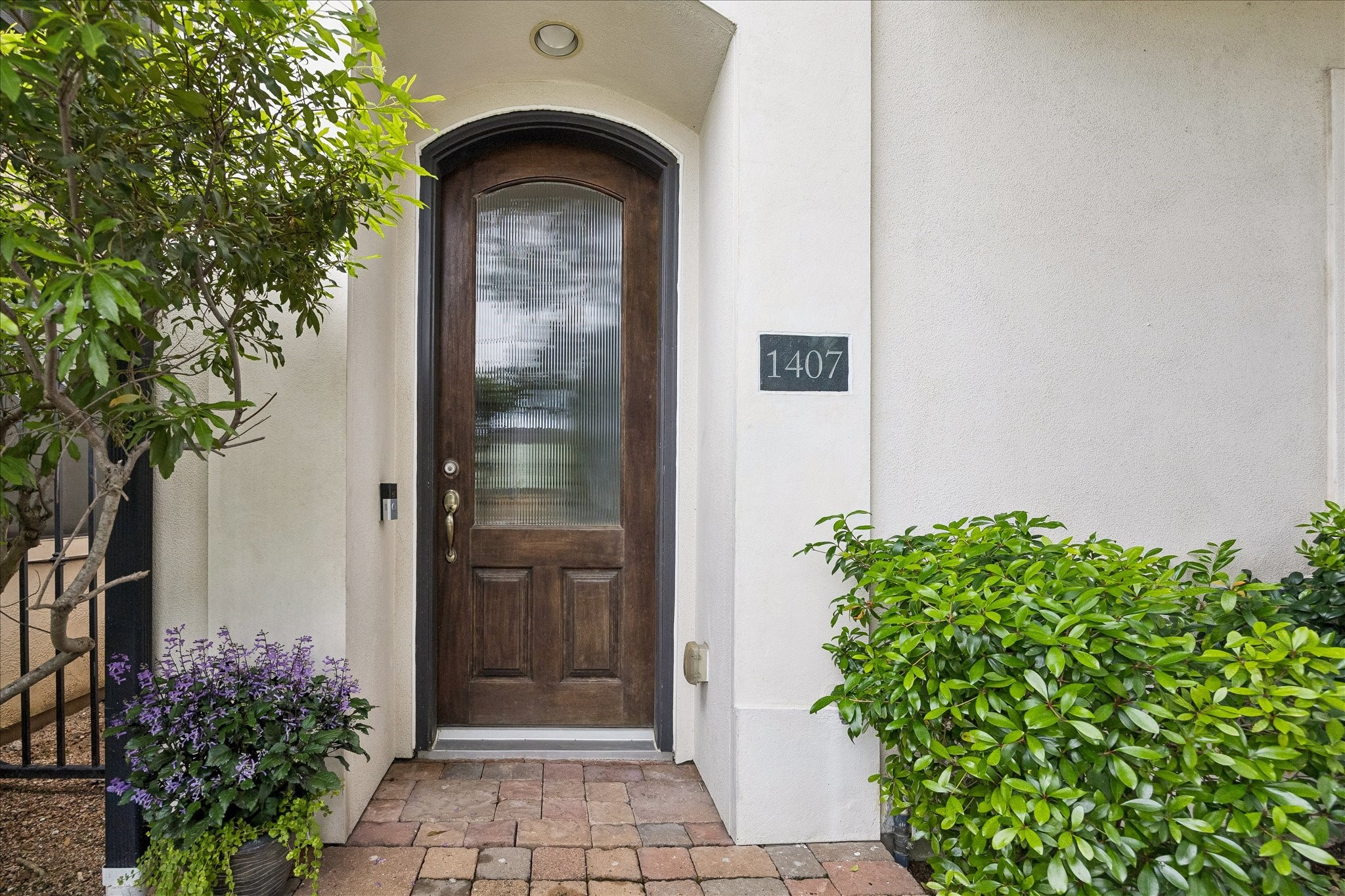 1407 Shearn Street Houston, TX 77007 - Photo 2 of 35 Beautifully landscaped, paved entry way leading to a fluted glass door.