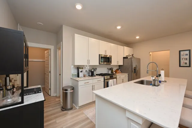 a kitchen with sink a stove and refrigerator