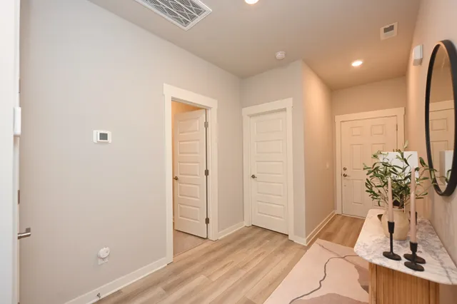 a view of an entryway with wooden floor