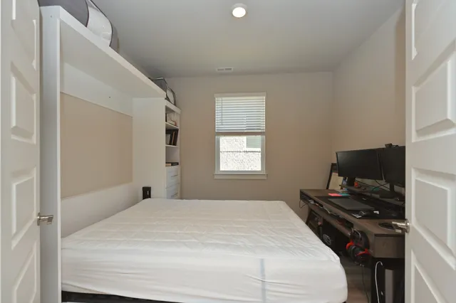 a bedroom with a bed and a window