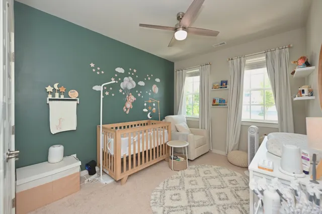 a bed room with a bed window and a chandelier