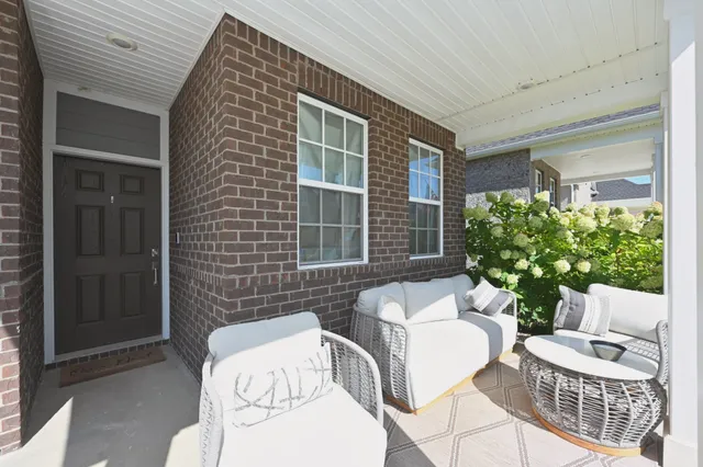 a view of a patio with couches table and chairs and potted plants