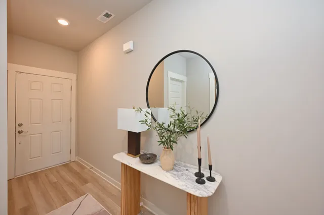 a living room with furniture and a mirror